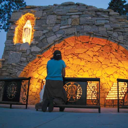 A woman prays at Mary's Grotto